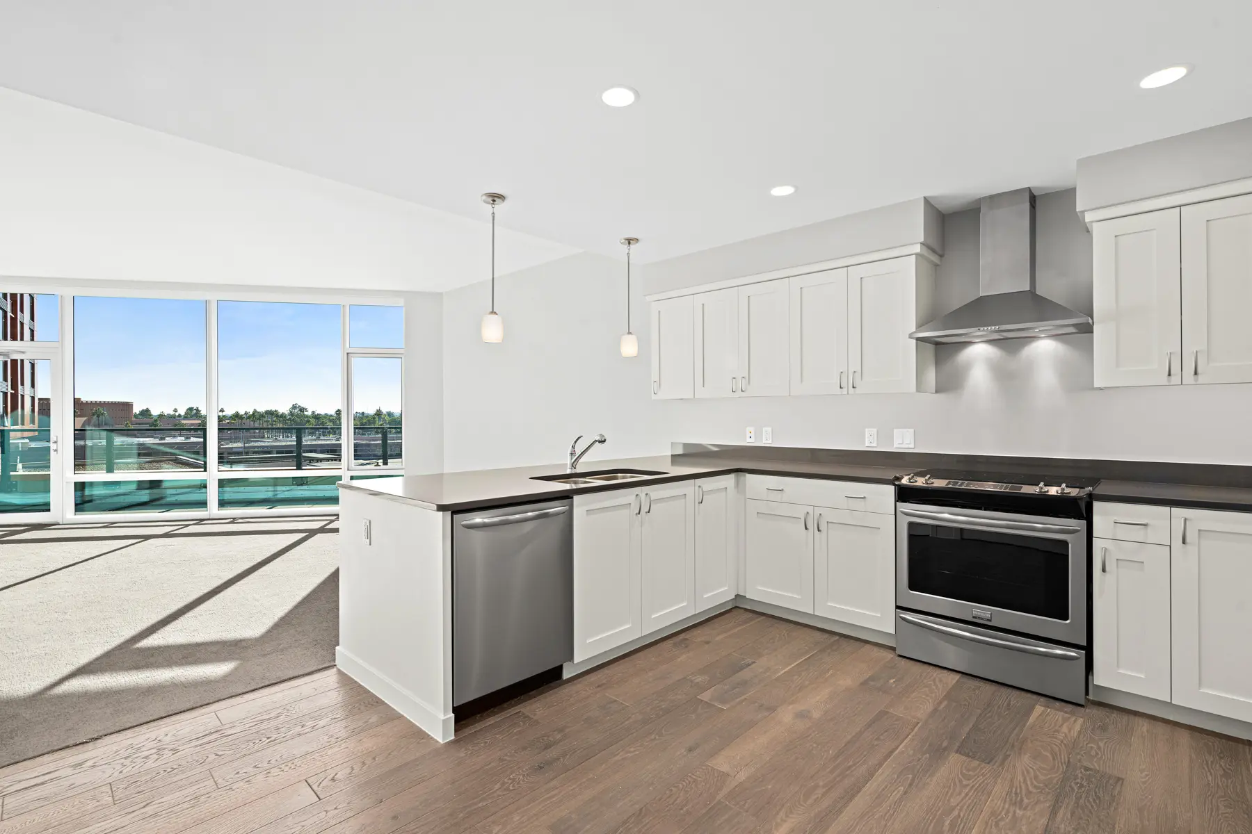 Interior of an apartment kitchen with floor to ceiling windows